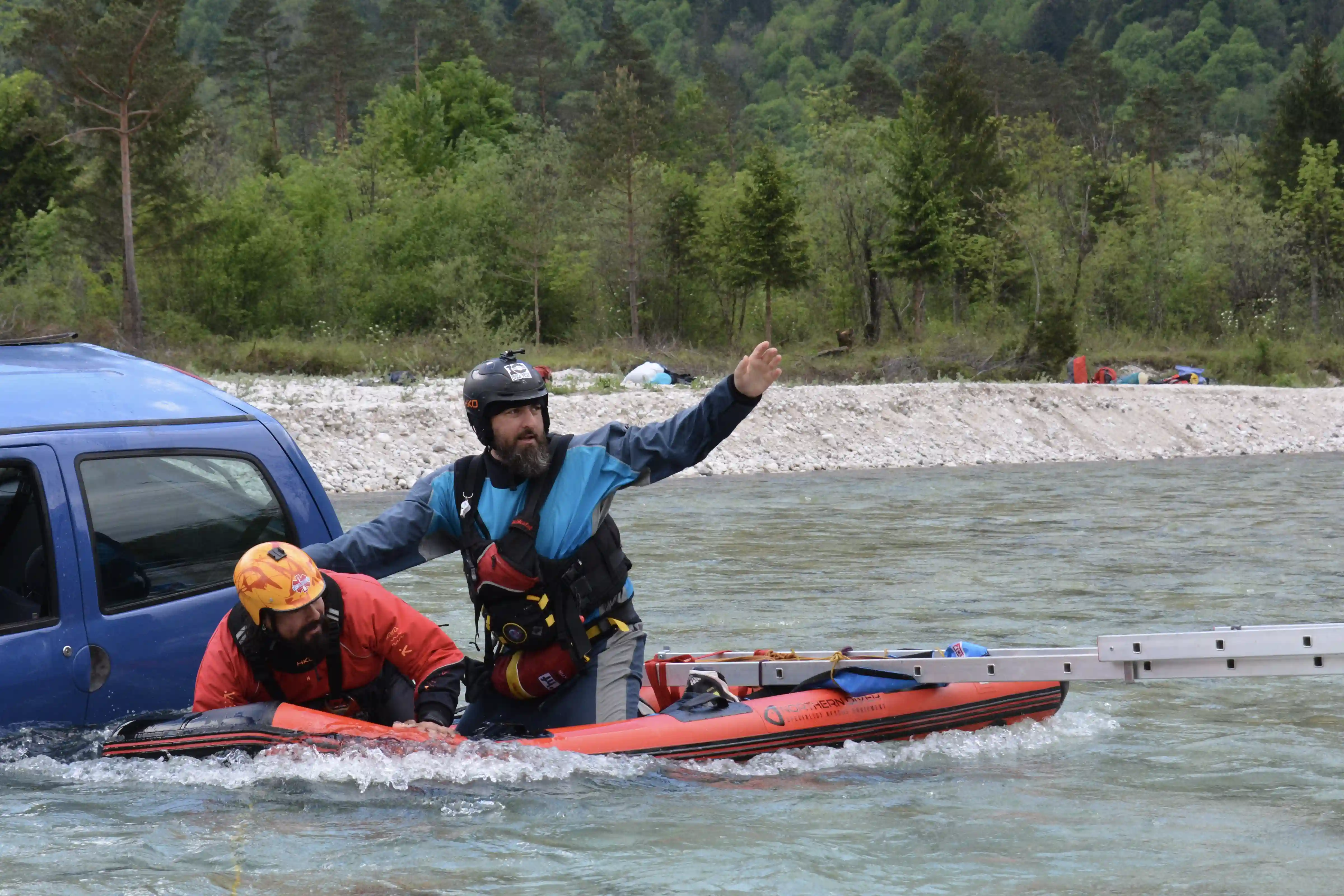 Rescue 3 Vehicles From Water Saving Person From Trunk Of A Car In a River With A Raft And People On The Banks