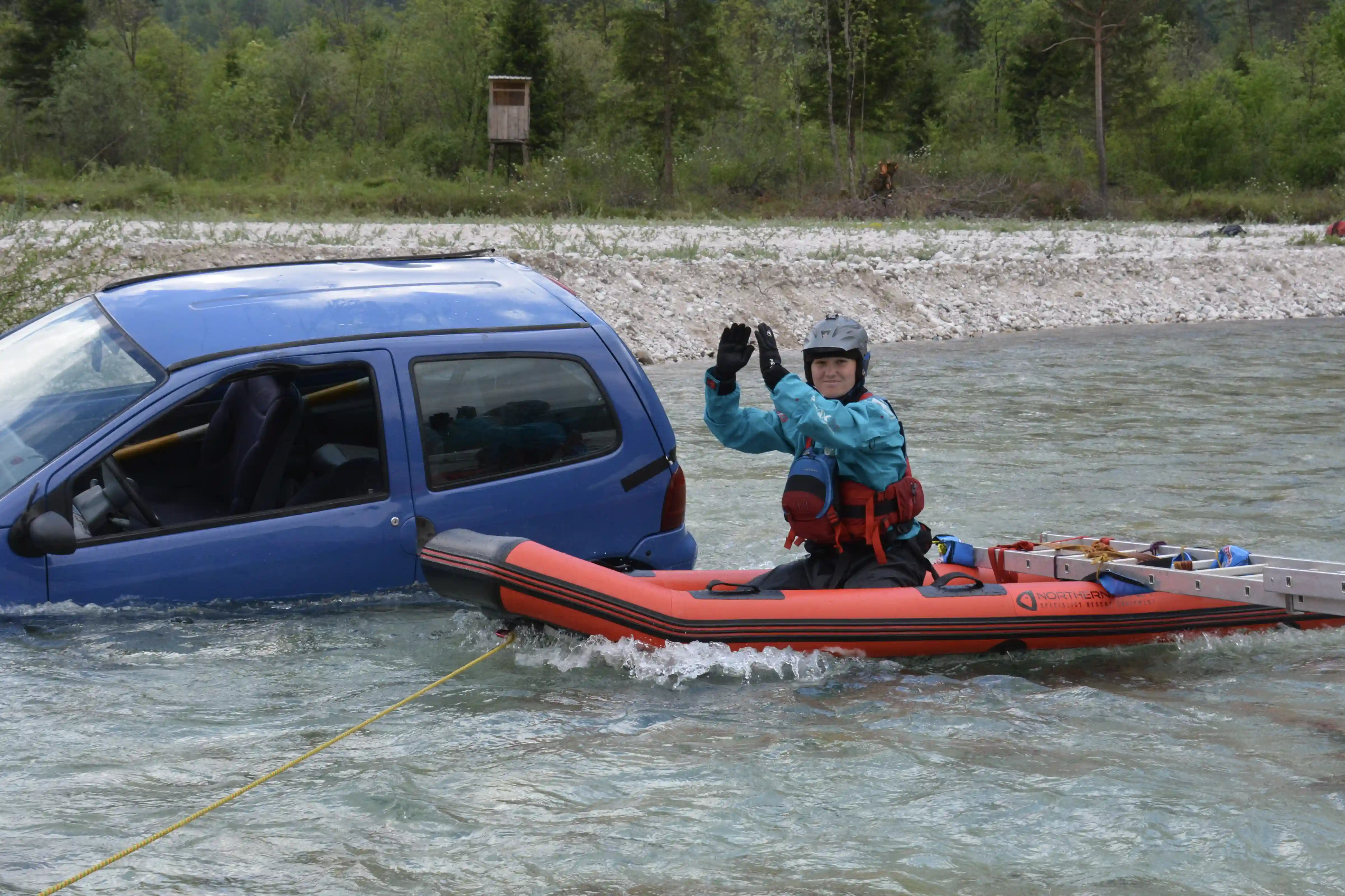 Rescue 3 Vehicles From Water Saving Person From Trunk Of A Car In a River With A Raft And People On The Banks